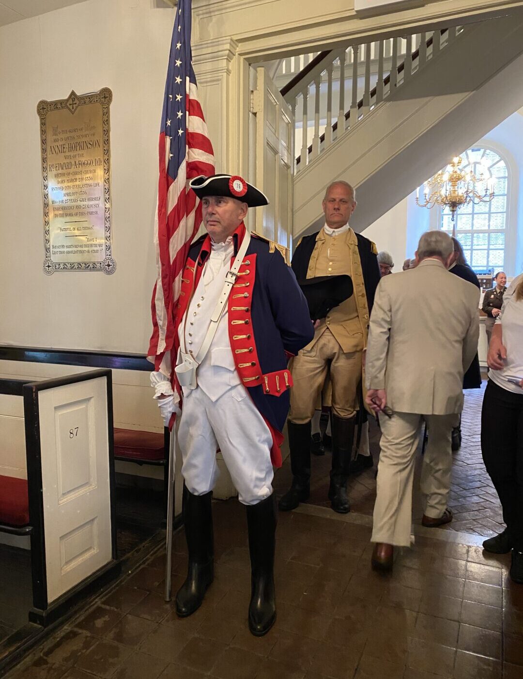 Soujourner with Flag leading procession into Christ Church